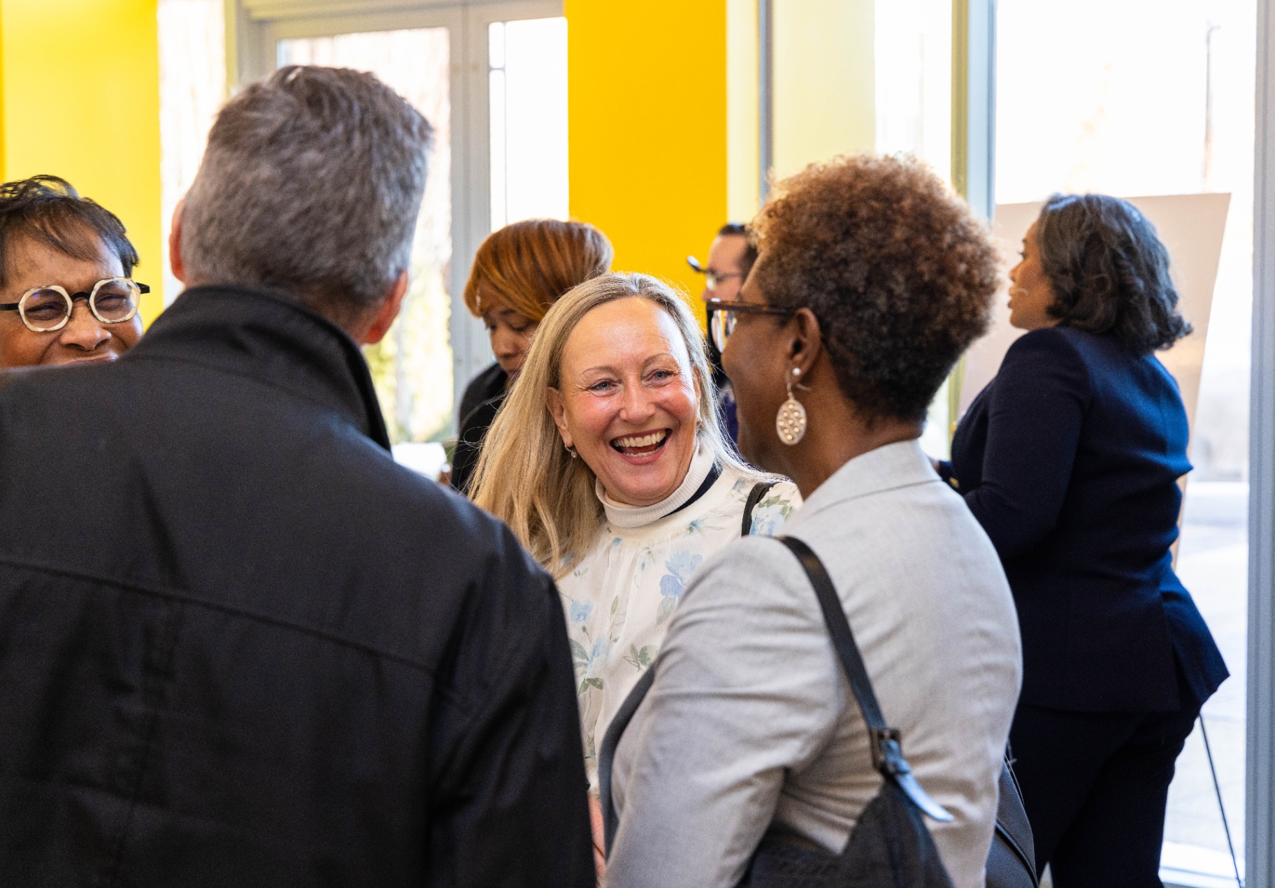 Community partners and supporters share a laugh at the BDCIG launch
